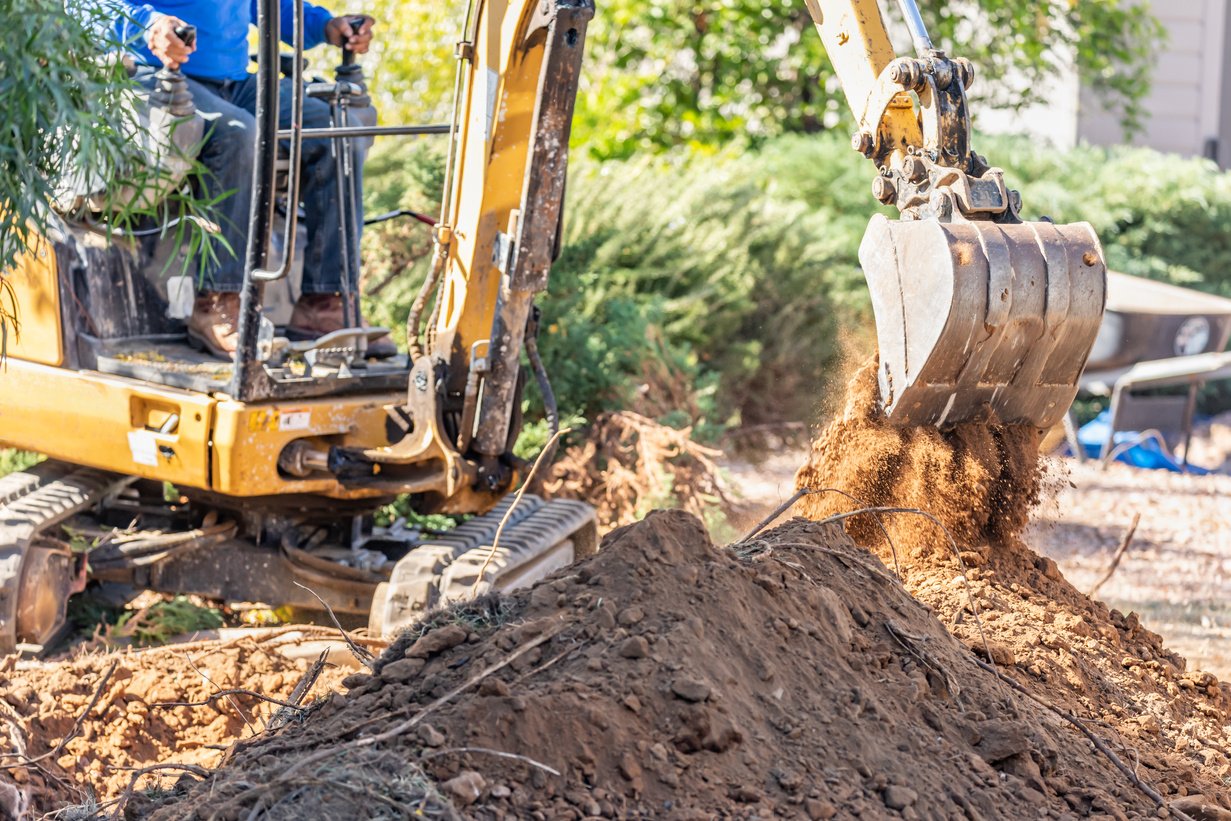 Working Excavator Tractor Digging a Trench at Construction Site